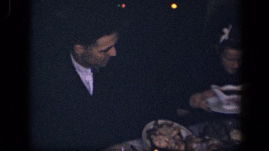 1942: family sitting down to eat candlelight feast. SEBRING OHIO