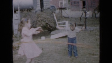 1958: Two Young Girls Playing With Hula Hoops in Backyard Minnesota
