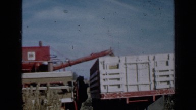 1958: man climbing large red tractor and leads him to reap sowing MINNESOTA