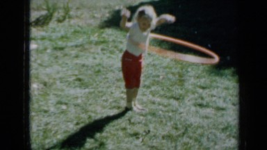 1958: three girls playing with hula hoop on grass MINNESOTA