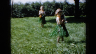 1958: two little twin kids are dancing with their puppies at forest MINNESOTA