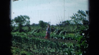 1958: women standing outside in windy garden MINNESOTA