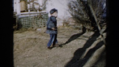 1958: small boy is running in front of some people and dog MINNESOTA