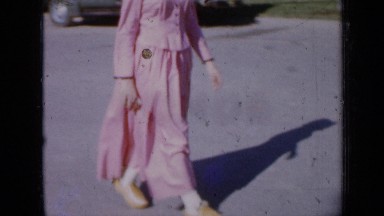 1959: woman and two young girls dressed in costumes, on city street IOWA