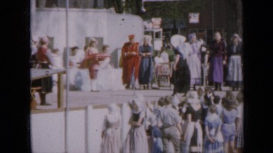 1959: large gathering of people outside in costumes as people look on IOWA