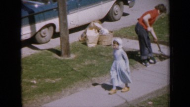 1959: the mother is working on land and her child smell roses IOWA