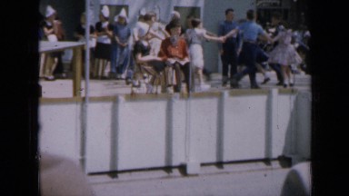 1959: group of children holding hands in circle with someone in middle. IOWA