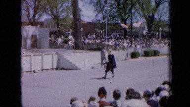 1959: Parade of Costumed and Suited People Walk Down Street Iowa