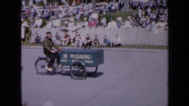1959: the tricycle was going and woman were walking people were watching IOWA
