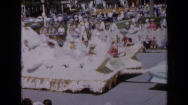 1959: girls are sitting in vehicle like queens which are in rally IOWA