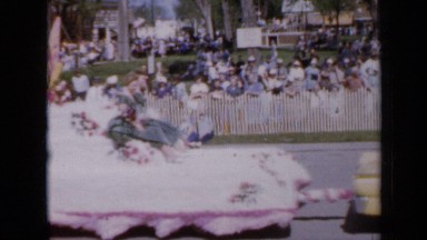 1959: Band Marching Down Street with Floats During Parade Iowa