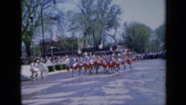 1959: group of cheerleaders marching and dancing for observers IOWA