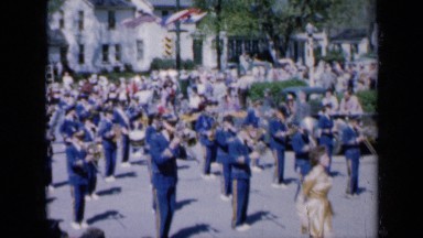 1959: band march past and lady looking flower pot IOWA