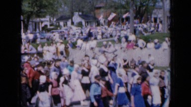 1959: people walking in street like marchpasting IOWA