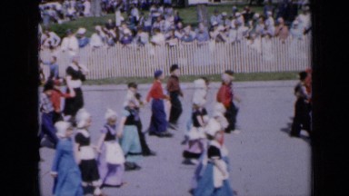 1959: many children walking and waving hands in parade IOWA