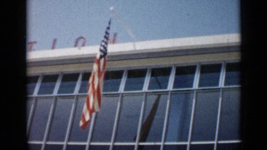 1962: american and french flags on hanging outside modern building