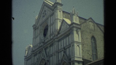 1962: scene of church building and people walking around right next to it.
