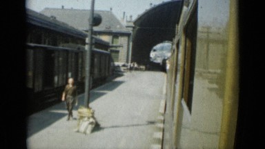 1962: train leaving stop as man walks along it. MONACO