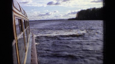 1971: tourist boat with big windows travelling very high speed in quiet waters