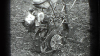 1975: young man stands on field with mowing machine RUSSIA