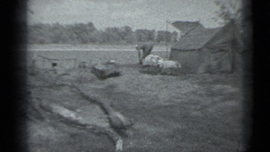 1983: man is working in field and standing along with his tent