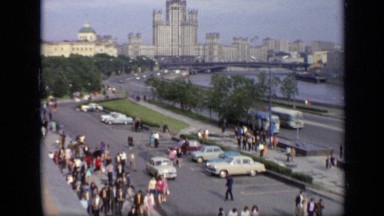 1971: crowd of peoples walking with busy road and car are going. MOSCOW RUSSIA