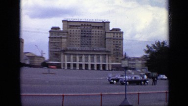 1971: clean city and properly managed, cars are moving as well. sky seems clear.