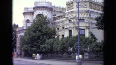 1971: cars and pedestrians pass by castle located in busy city. MOSCOW RUSSIA