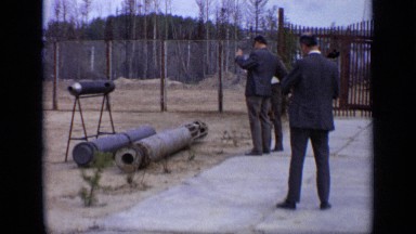 1971: three men look at three metal tubes placed within outdoor enclosure MOSCOW