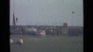 1967: military vehicles in field on display with civilians walking by