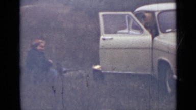 1967: couple parked their car in countryside on chilly morning and enjoying tea