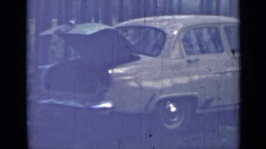 1967: yellow car with trunk open parked in wooded lot RUSSIA