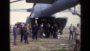 1971: Persons Standing Near Rocket Structure Vehicle