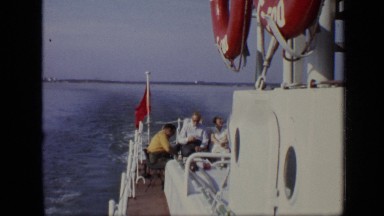 1971: some peoples are riding in boat during morning and enjoying their vacation