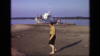 1971: three men walking on beach of sea with small ship MOSCOW RUSSIA