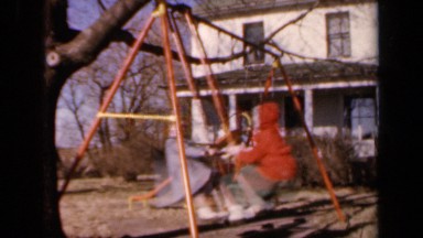 1964: two children swinging on standing swingset KANSAS