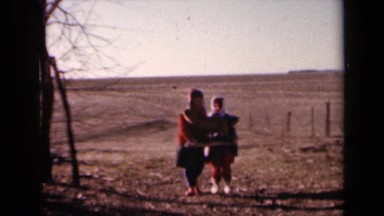 1964: two children carry stuffed fox through field KANSAS
