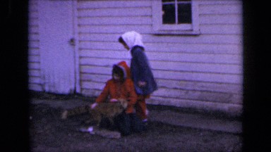 1964: two girls on grass rubbing fox. KANSAS