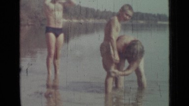 1967: mom help bathing of two naughty sons in water of river RUSSIA