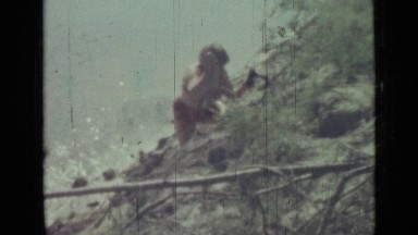 1967: old women going down on hill with utensils to water
