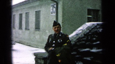 1963: Man in Military Uniform Waves as He Leaves on Snowy Day