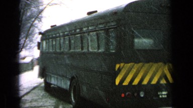 1963: bus taking turn and then travelling straight on road covered with snow