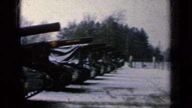 1963: large row of powerful military tanks, covered with plastic tarps GERMANY