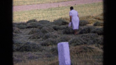 1963: woman in dress turning hay RUSSIA