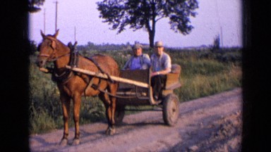 1963: two people in wagon being pulled as another person walks up