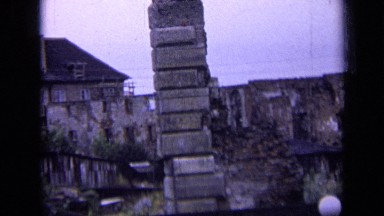 1963: very old buildings,pillars and trees around reconstruction of old house