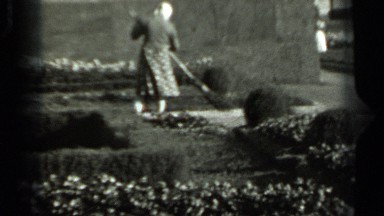 1963: the old lady is brooming garden RUSSIA