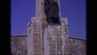1963: very big structure with statue standing above it and people on stairs
