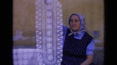 1963: lady from middle east displaying her intricate design on cloth