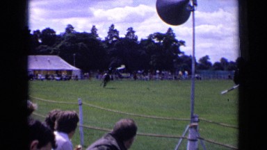 1963: horse running in green fields and people's watching them ENGLAND
